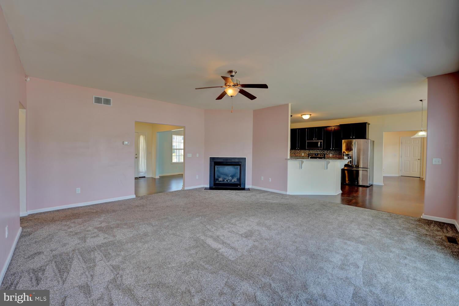 167 Spring Dale Lane Felton, DE 19943 - Photo 16 of 54 a view of an empty room with a window and a kitchen