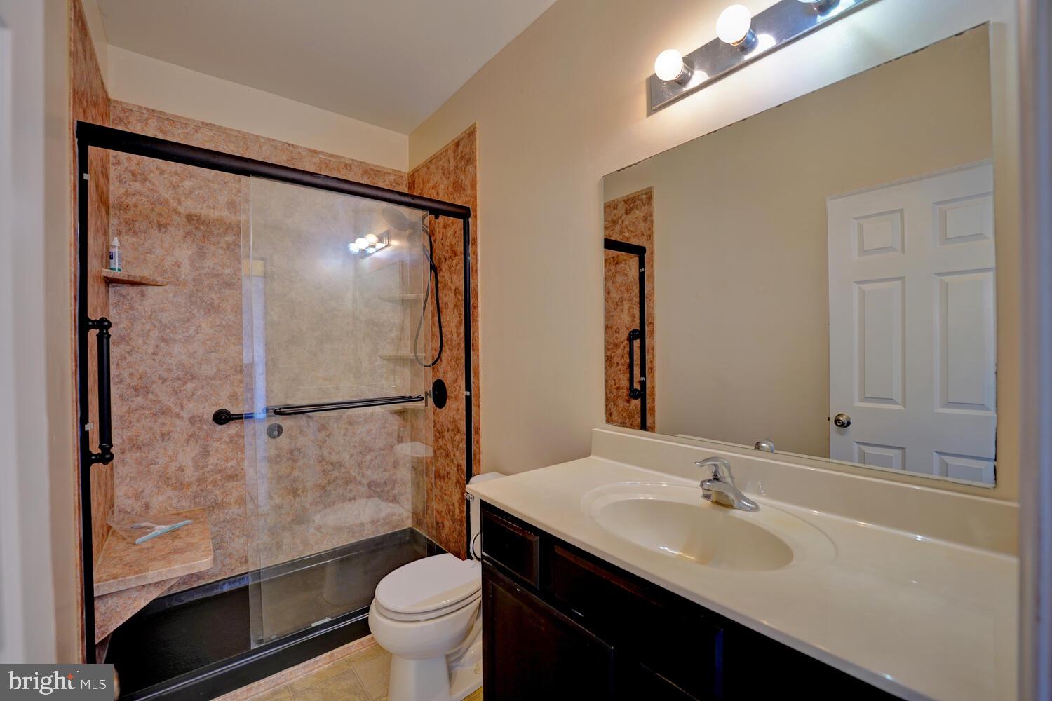 167 Spring Dale Lane Felton, DE 19943 - Photo 38 of 54 a bathroom with a granite countertop sink toilet and shower