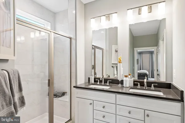 a bathroom with a double vanity sink and a mirror