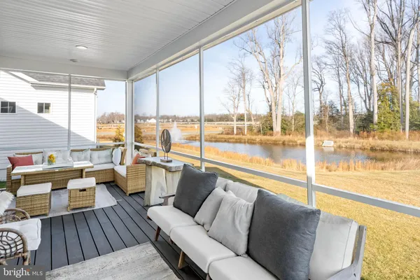 a view of a house with swimming pool and porch with furniture