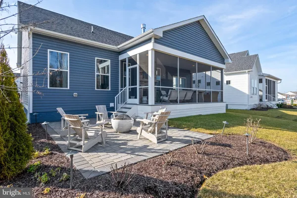 a view of a house with backyard porch and sitting area