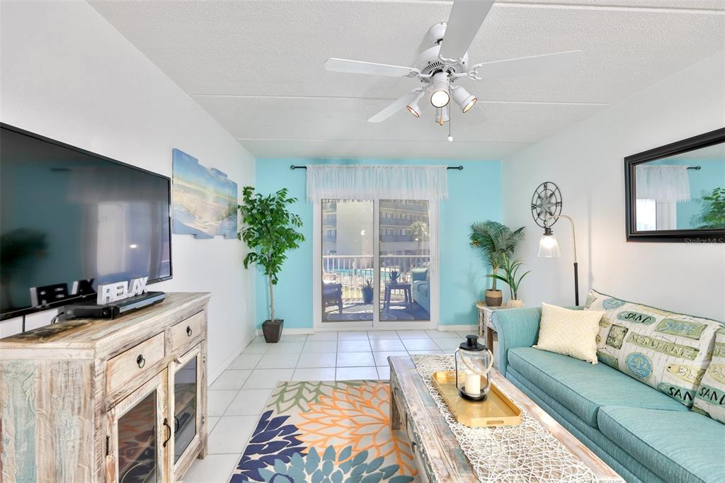 8901 Blind Pass Road, Unit 224 St. Pete Beach, FL 33706 - Photo 17 of 46 a living room with furniture and a fireplace
