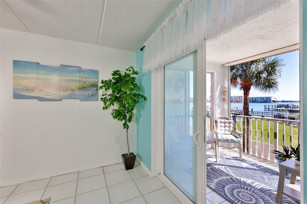 8901 Blind Pass Road, Unit 224 St. Pete Beach, FL 33706 - Photo 18 of 46 a vase of flowers sitting on a table in front of a window