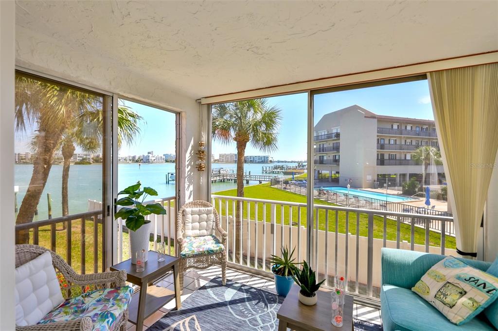 8901 Blind Pass Road, Unit 224 St. Pete Beach, FL 33706 - Photo 19 of 46 a living room with furniture and floor to ceiling windows
