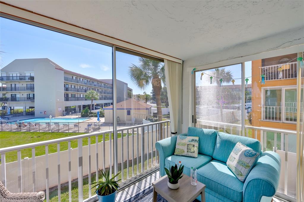 8901 Blind Pass Road, Unit 224 St. Pete Beach, FL 33706 - Photo 20 of 46 a view of a porch with furniture