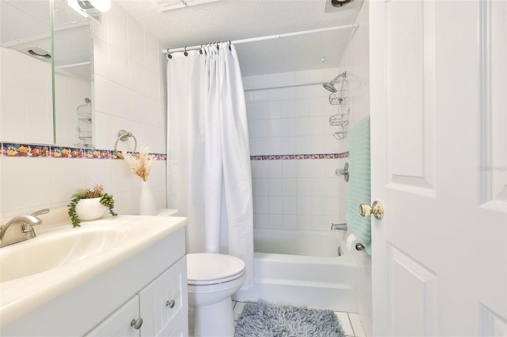 8901 Blind Pass Road, Unit 224 St. Pete Beach, FL 33706 - Photo 25 of 46 a bathroom with a sink toilet and shower