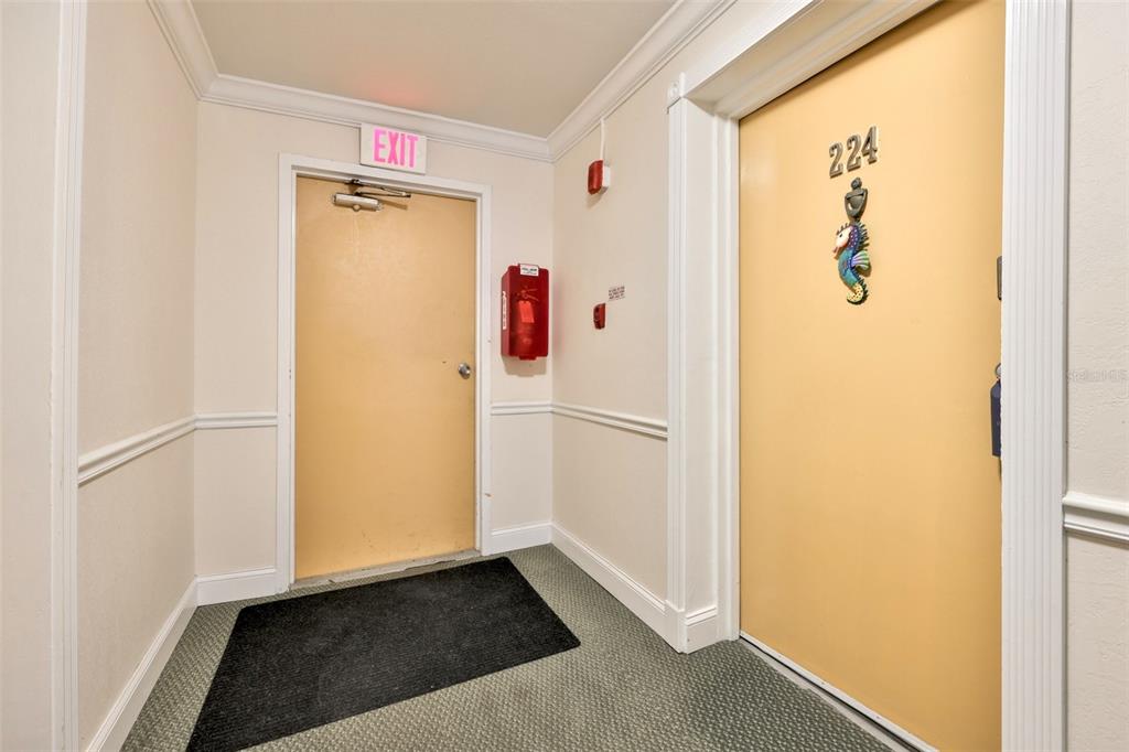 8901 Blind Pass Road, Unit 224 St. Pete Beach, FL 33706 - Photo 3 of 46 a view of hallway with closet and wooden floor