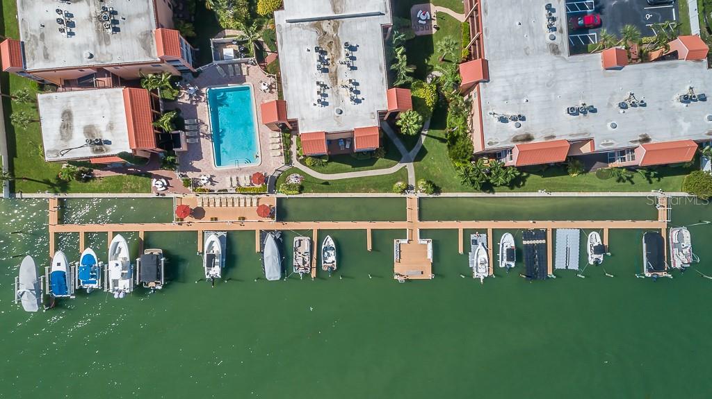 8901 Blind Pass Road, Unit 224 St. Pete Beach, FL 33706 - Photo 33 of 46 a view of building with garden