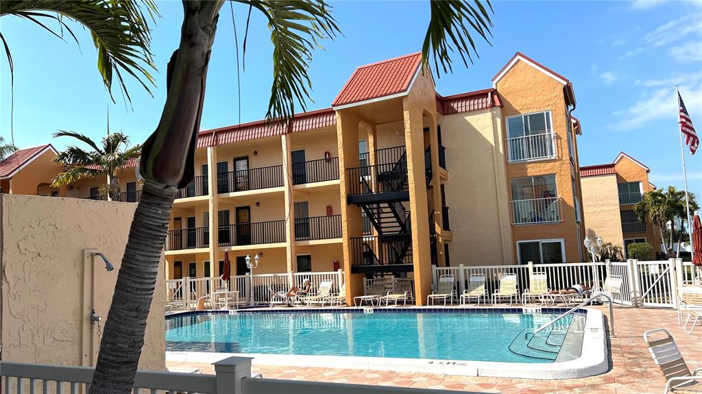 8901 Blind Pass Road, Unit 224 St. Pete Beach, FL 33706 - Photo 35 of 46 a view of a house with a swimming pool