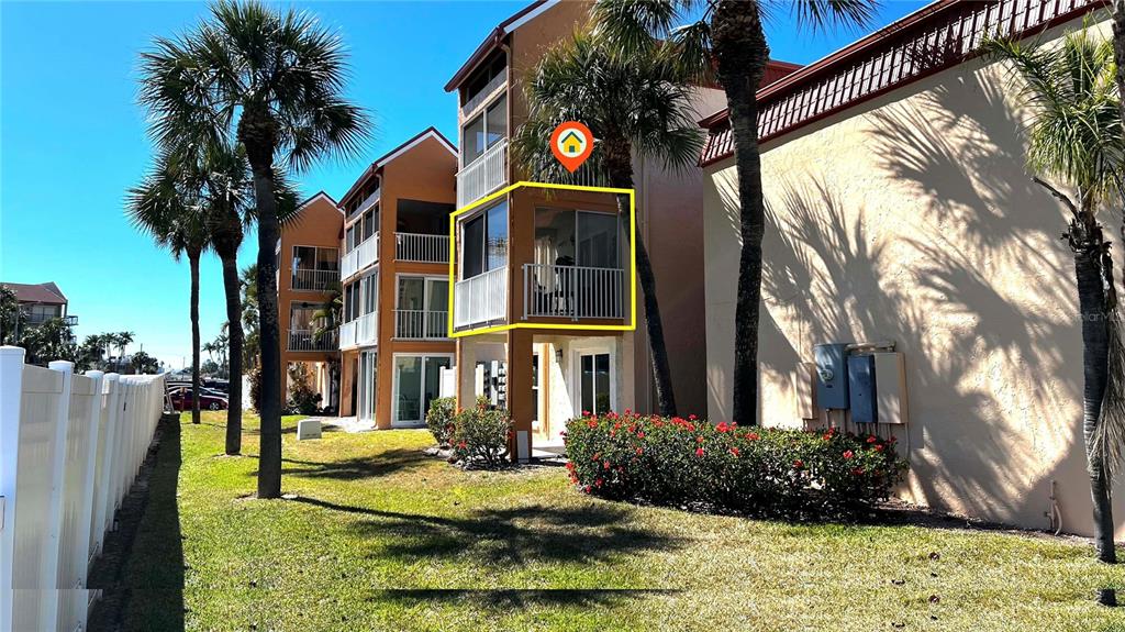 8901 Blind Pass Road, Unit 224 St. Pete Beach, FL 33706 - Photo 42 of 46 a front view of a house with a yard