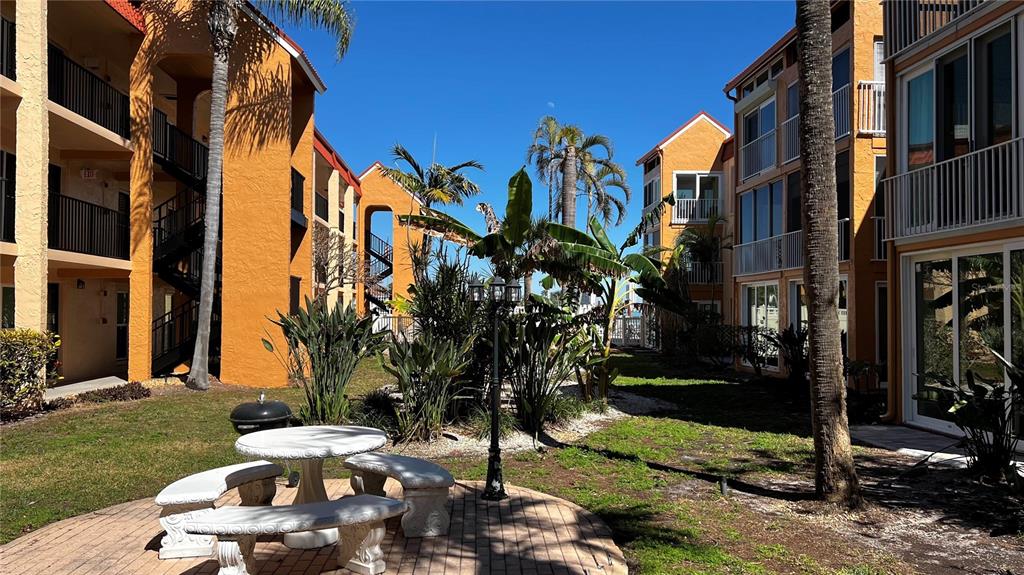 8901 Blind Pass Road, Unit 224 St. Pete Beach, FL 33706 - Photo 43 of 46 a view of a house with a yard