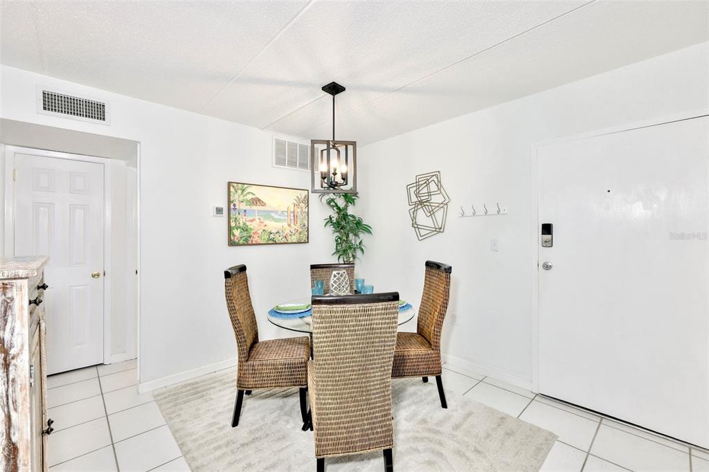 8901 Blind Pass Road, Unit 224 St. Pete Beach, FL 33706 - Photo 5 of 46 a dining room with furniture and window