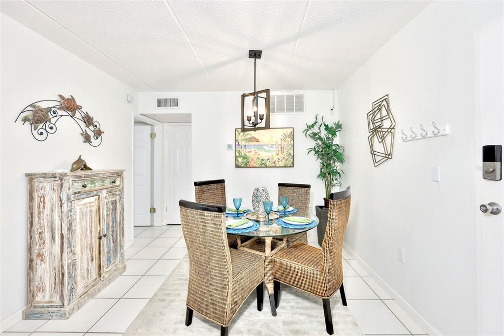 8901 Blind Pass Road, Unit 224 St. Pete Beach, FL 33706 - Photo 6 of 46 a dining room with furniture and window