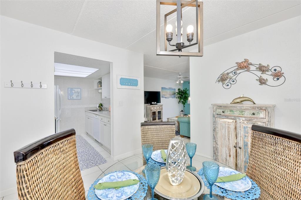 8901 Blind Pass Road, Unit 224 St. Pete Beach, FL 33706 - Photo 7 of 46 a dining room with furniture a rug and wooden floor