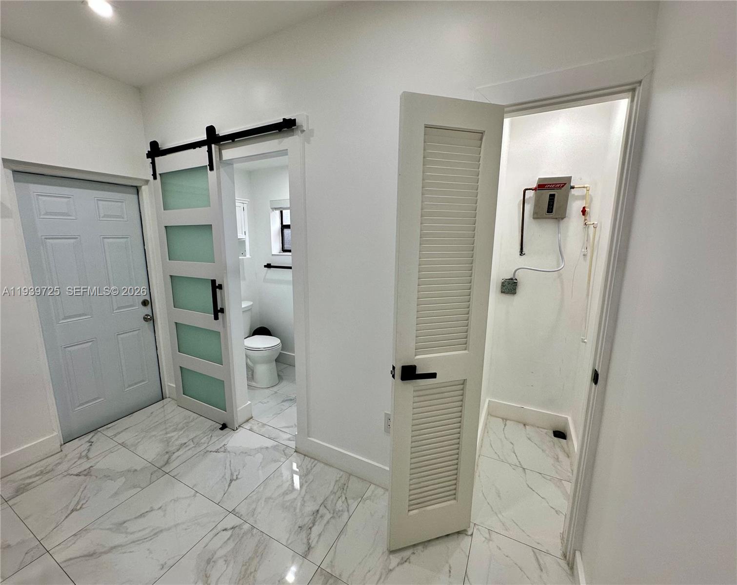 1309 Northwest 55th Terrace, Unit STUDIO Miami, FL 33142 - Photo 8 of 18 a bathroom with a shower and a sink