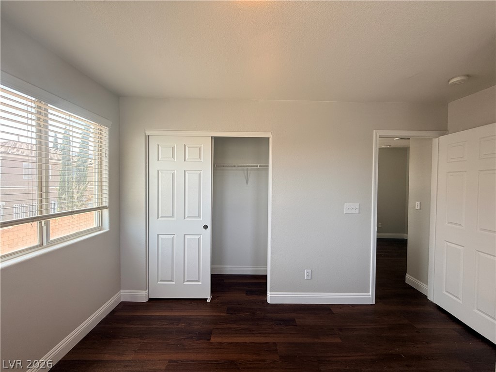 11953 Fairfax Ridge Street Las Vegas, NV 89183 - Photo 19 of 32 Rich hardwood floors complement the natural light streaming through large windows in this cozy bedroom.
