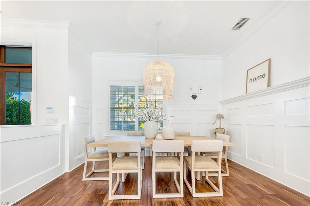Undisclosed Address Naples, FL 34102 - Photo 12 of 44 a dining room with furniture and wooden floor