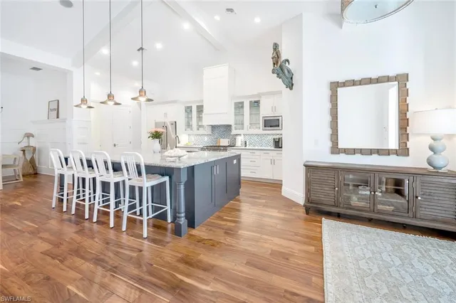 a large kitchen with stainless steel appliances kitchen island granite countertop a large counter top and stove