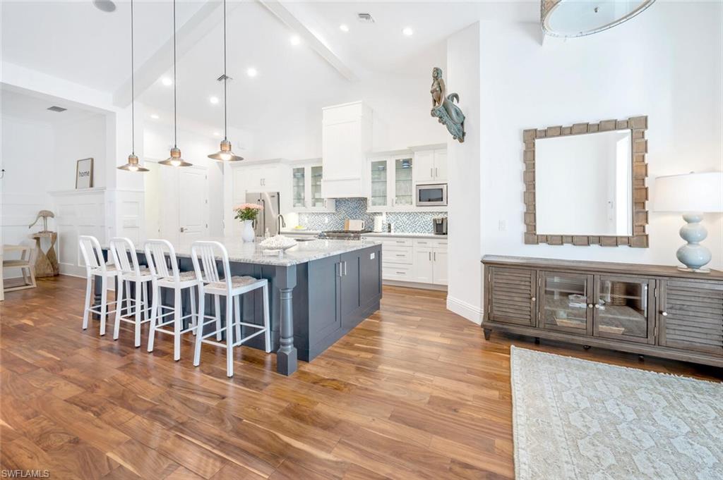 Undisclosed Address Naples, FL 34102 - Photo 13 of 44 a large kitchen with stainless steel appliances kitchen island granite countertop a large counter top and stove