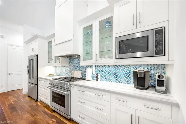 a kitchen with granite countertop cabinets stainless steel appliances and sink