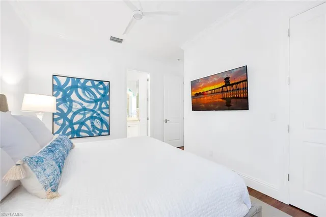 a bedroom with a bed and a painting on the wall