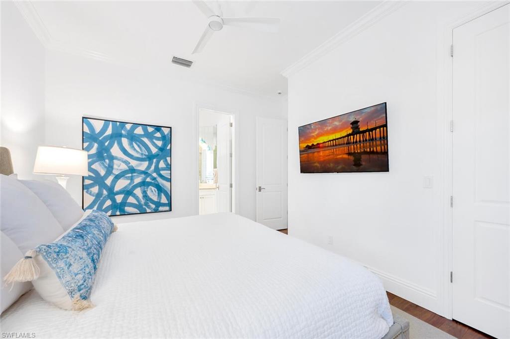 Undisclosed Address Naples, FL 34102 - Photo 24 of 44 a bedroom with a bed and a painting on the wall