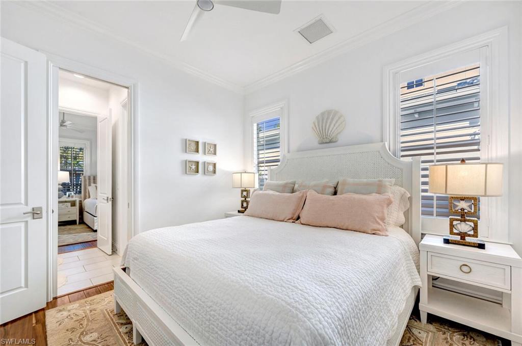 Undisclosed Address Naples, FL 34102 - Photo 27 of 44 a bedroom with a large bed and a window