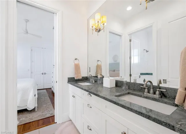 a bathroom with double vanity sinks and a mirror