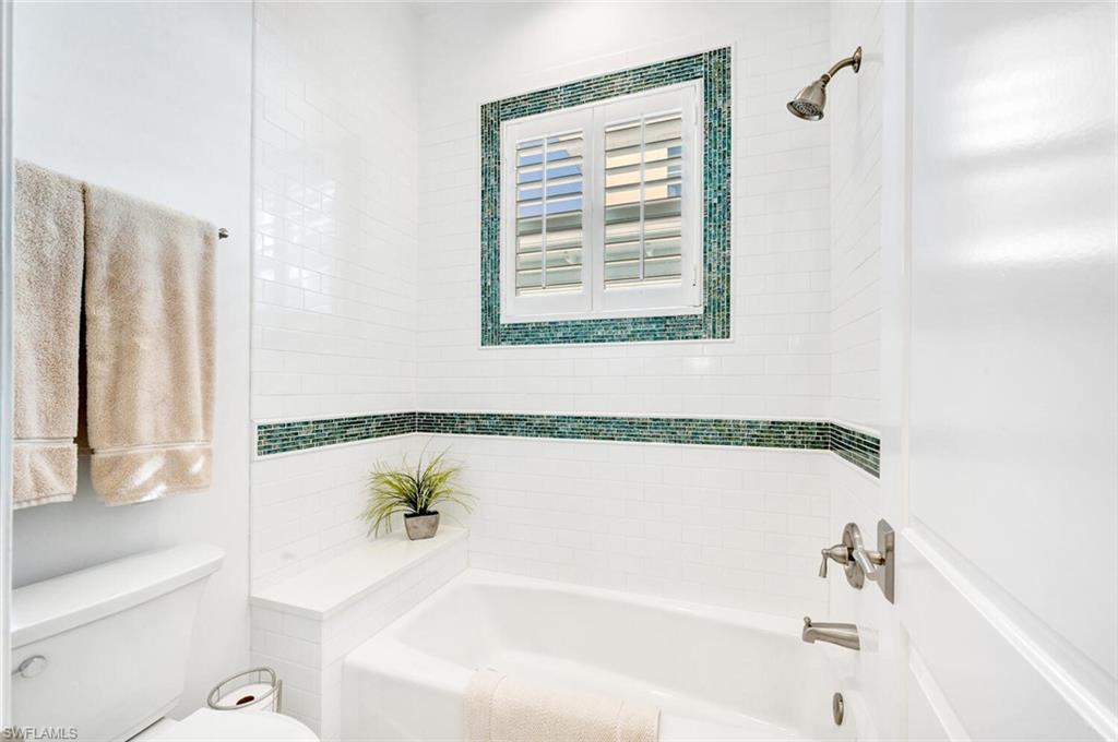 Undisclosed Address Naples, FL 34102 - Photo 29 of 44 a bathroom with a bathtub and a shower