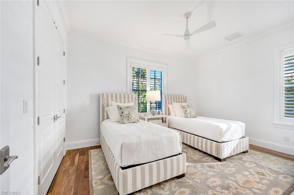 Undisclosed Address Naples, FL 34102 - Photo 30 of 44 a bedroom with a bed and a night stand