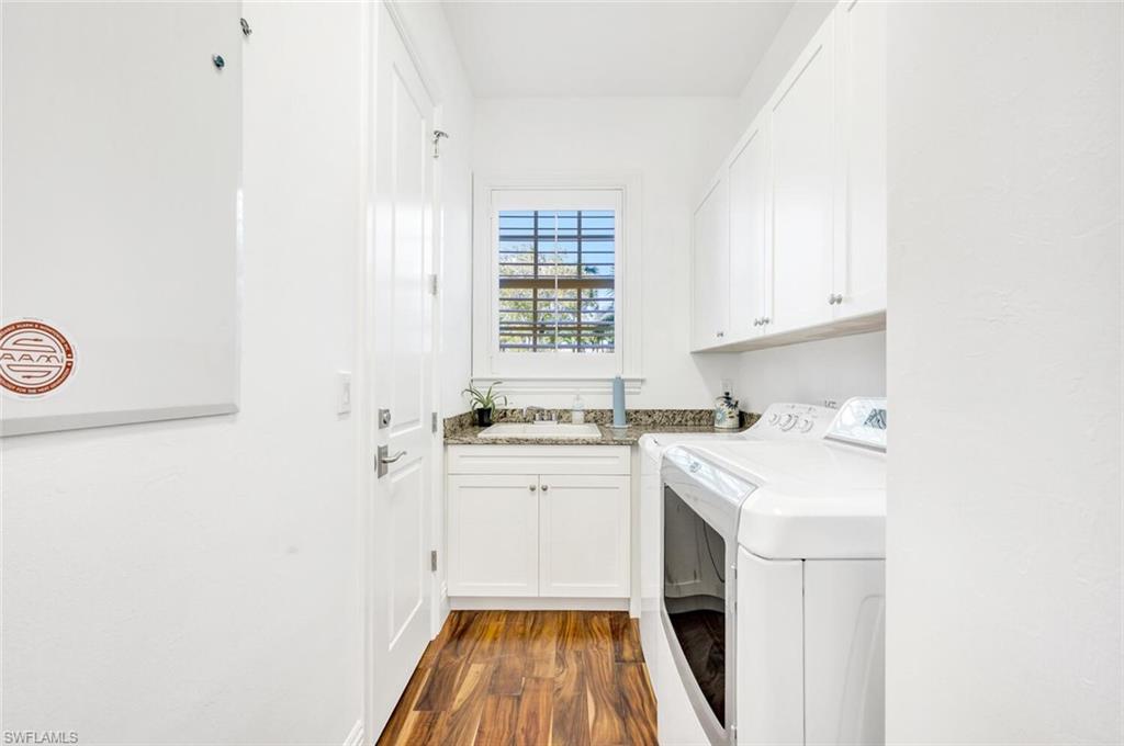 Undisclosed Address Naples, FL 34102 - Photo 31 of 44 a room with a sink a washer and dryer