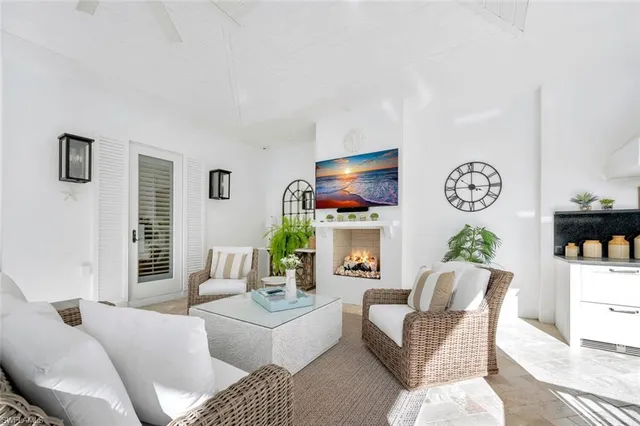 a living room with furniture a chandelier and a flat screen tv