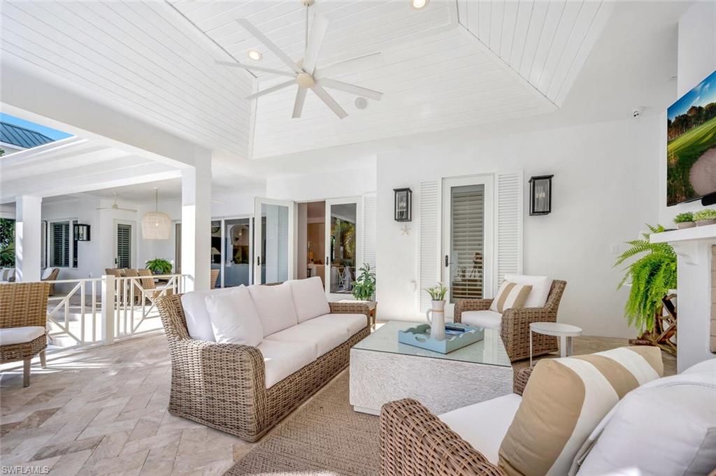Undisclosed Address Naples, FL 34102 - Photo 36 of 44 a living room with furniture a flat screen tv and a large window