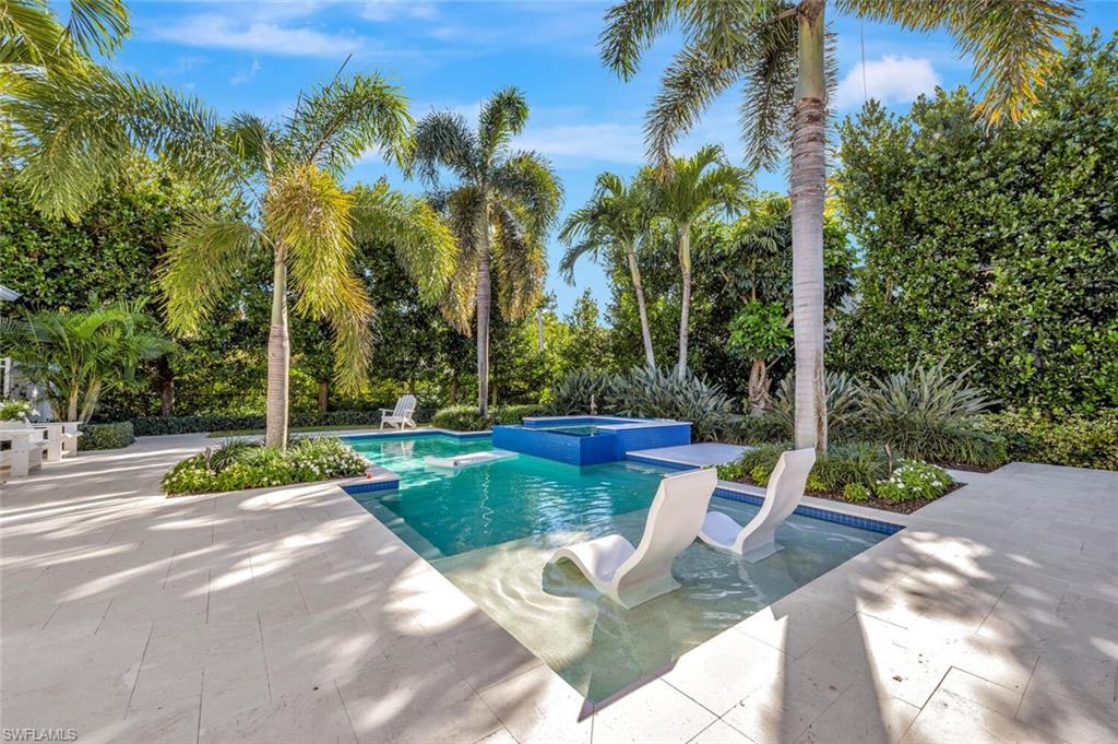 Undisclosed Address Naples, FL 34102 - Photo 38 of 44 a view of a garden with a slide