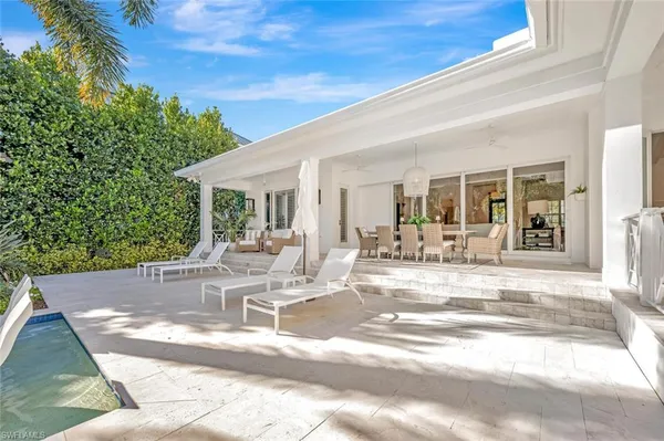 a view of a swimming pool with outdoor seating