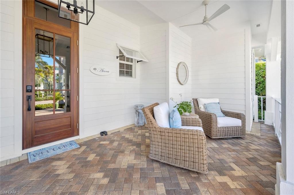 Undisclosed Address Naples, FL 34102 - Photo 5 of 44 a bedroom with a bed a couch and a window