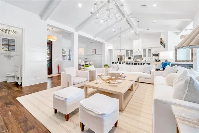 a living room with lots of furniture and view of kitchen
