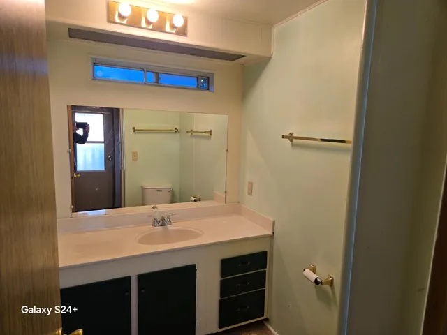 a kitchen with a sink and cabinets
