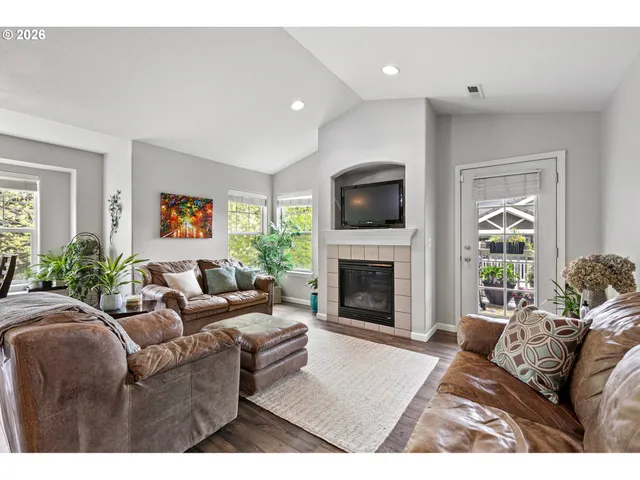 a living room with furniture a fireplace and a flat screen tv