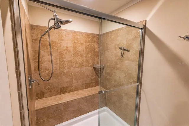 a bathroom with a glass shower door