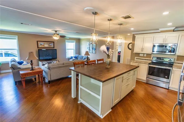 a kitchen with sink stove and refrigerator