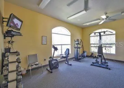 a living room with furniture a chandelier and a large window