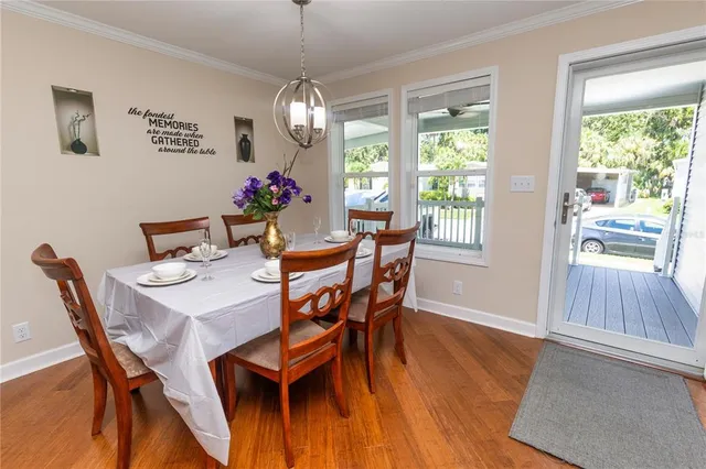 a view of a dining room with furniture window and wooden floor