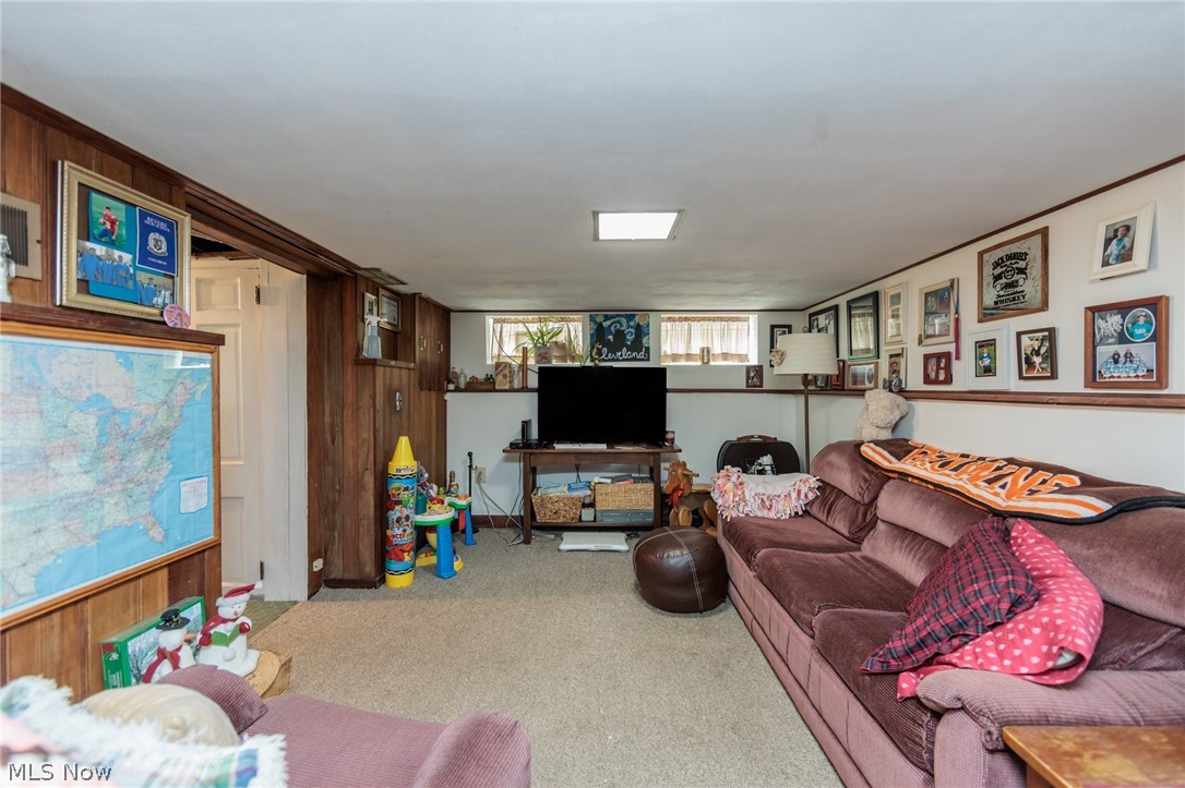 5364 Summit Road Lyndhurst, OH 44124 - Photo 28 of 42 Carpeted interior space featuring wood paneling on lower walls, white upper walls, and a white ceiling