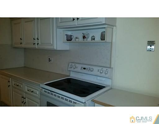21 Haven Road Old Bridge, NJ 08857 - Photo 5 of 8 a kitchen with a stove and a cabinets