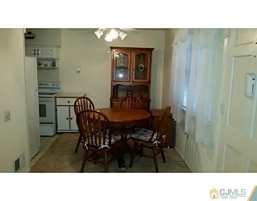 21 Haven Road Old Bridge, NJ 08857 - Photo 6 of 8 a kitchen with a table and chairs