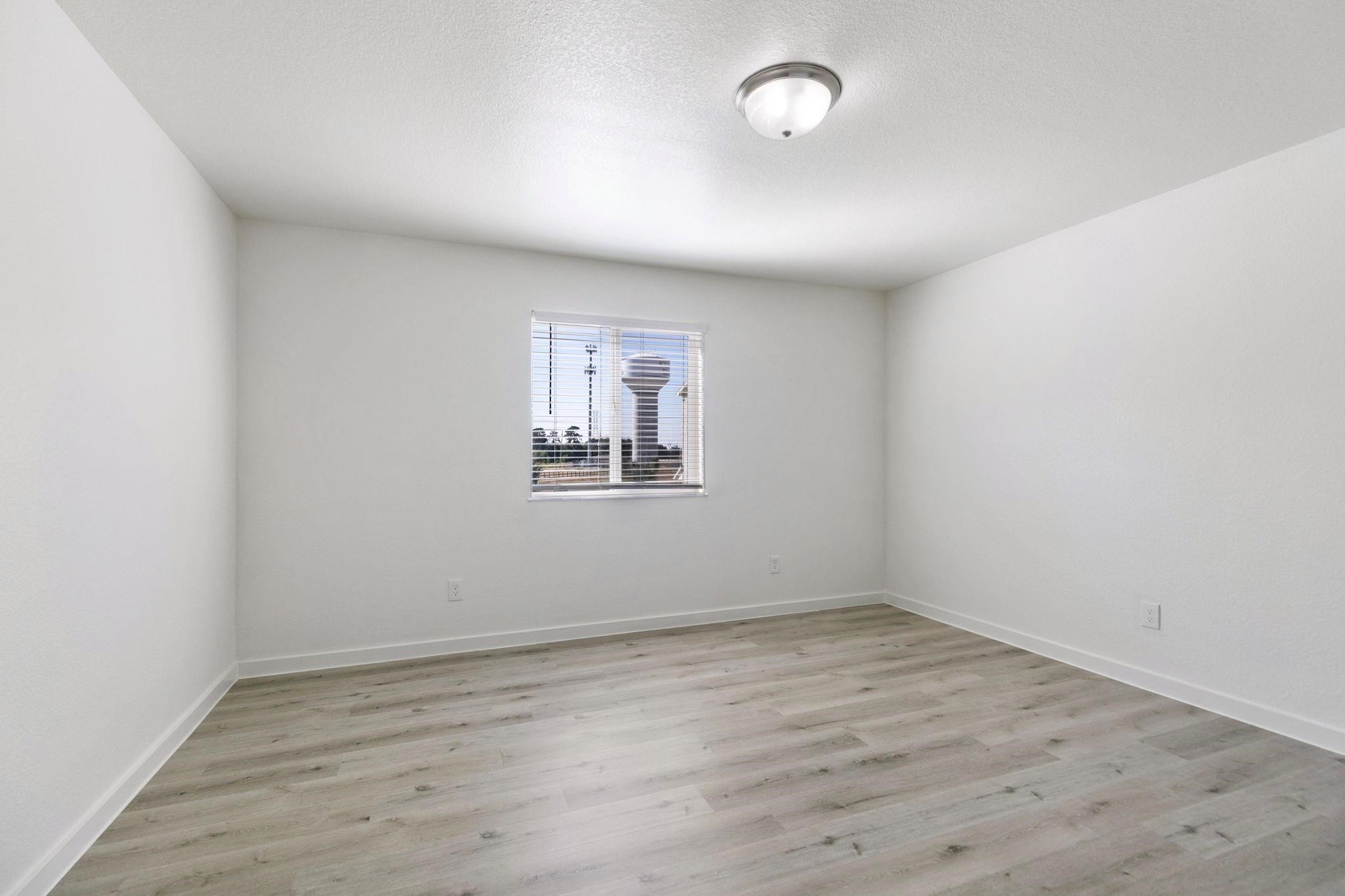 12603 Telge Road, Unit 27D Cypress, TX 77429 - Photo 11 of 27 an empty room with wooden floor and windows