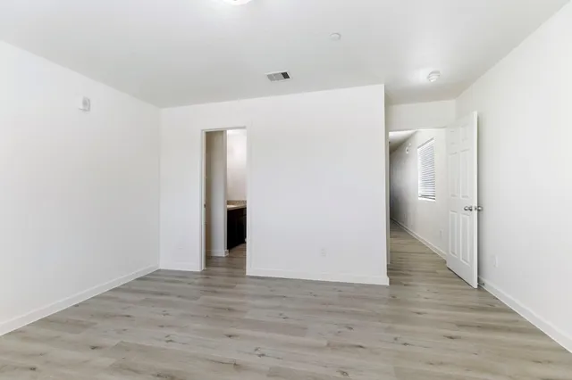 a bathroom with a granite countertop sink toilet and a mirror