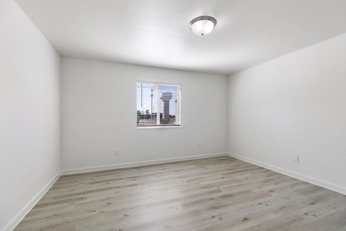 12603 Telge Road, Unit 27D Cypress, TX 77429 - Photo 12 of 27 an empty room with wooden floor and windows