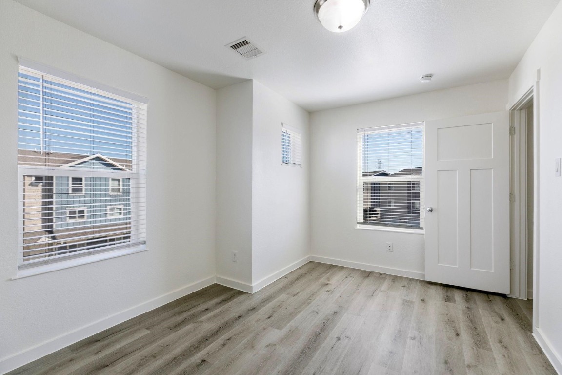 12603 Telge Road, Unit 27D Cypress, TX 77429 - Photo 16 of 27 a view of an empty room with wooden floor and a window
